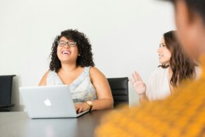 Women in the workplace laughing at computer